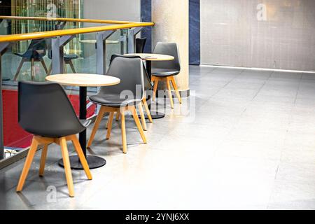 round tables with chairs in a supermarket cafe Stock Photo