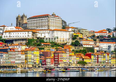 Porto, Portugal - July 17, 2024: Exterior architecture of the Episcopal Palace and the Porto Cathedral, with the cityscape and the Douro River in the Stock Photo