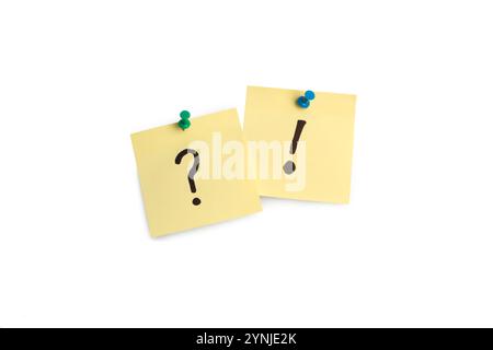 Exclamation mark and question mark drawn on a yellow sticky paper hanging on a white background Stock Photo