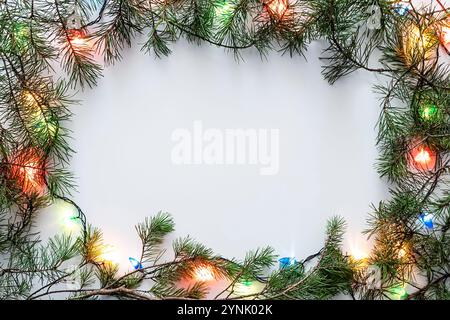 Christmas frame with Christmas ornaments and decorations. Garland on the Christmas tree. Square frame White. Stock Photo