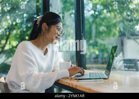 Business women working about new startup on laptop to analysis finance of project in outside office, Woman working using laptop online meeting in home Stock Photo