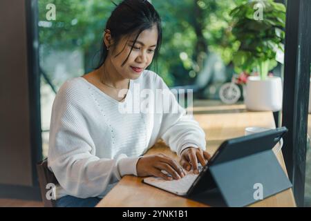Business women working about new startup on tablet to analysis finance of project in outside office, Woman working using tablet online meeting in home Stock Photo