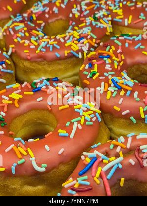 Goiania, Goias, Brazil – November 25, 2024: A  set of decorated donuts, covered in chocolate with sprinkles of various colors on top. Stock Photo