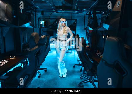 Stylish gamer in modern esports lounge with blue lighting Stock Photo