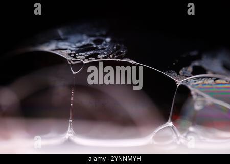 Silver liquid connections, bubble in macro, movement of liquid in a bubble, abstract background, surrealistic flow Stock Photo