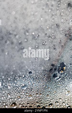 CLose Up of Condensation Bubbles and Marks on A Window Water Background Stock Photo
