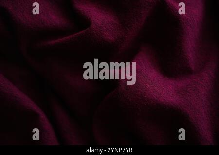 Closeup wrinkled burgundy jersey, soft fabric background. Stock Photo