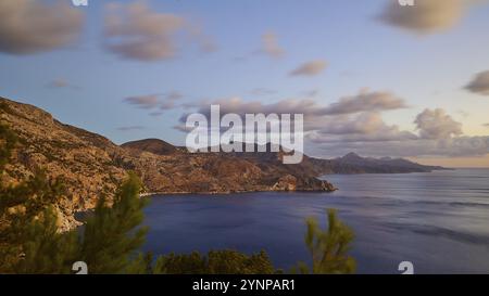 Coastal landscape with mountains, the sea and clouds under a blue sky, morning light, sunrise, coastal road, east coast, Karpathos, Dodecanese, Greek Stock Photo