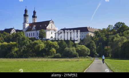 Cyclist on the Lauter valley cycle path in front of the former Obermarchtal monastery Stock Photo