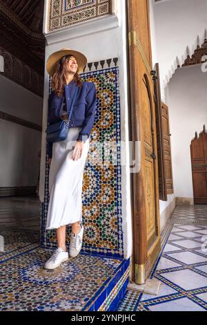 Young Dark Haired Woman in Navy Blazer and White Skirt Posing in Bahia Palace Marrakech, Morocco Stock Photo