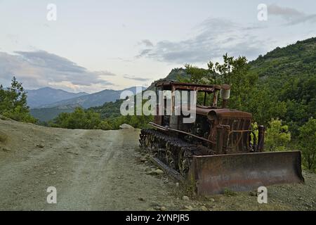 Rusty excavator in the national park Hotova Dangell demonstrates the effort which had to be taken to construct the road through the national park Stock Photo