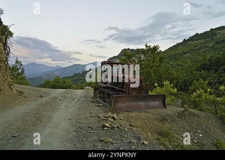 Rusty excavator in the national park Hotova Dangell demonstrates the effort which had to be taken to construct the road through the national park Stock Photo