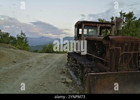 Rusty excavator in the national park Hotova Dangell demonstrates the effort which had to be taken to construct the road through the national park Stock Photo