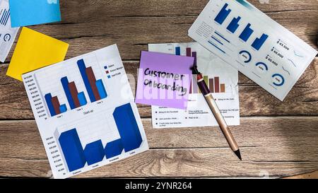 Concept of Customer Onboarding write on sticky notes isolated on Wooden Table. Stock Photo