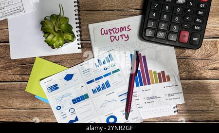 Concept of Customs Duty write on sticky notes isolated on Wooden Table. Stock Photo