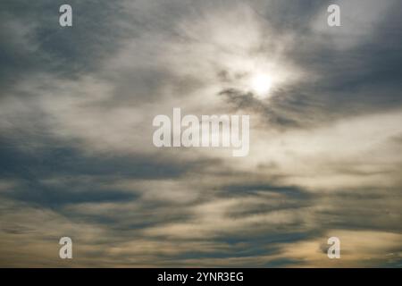 sun breaks through the storm clouds and overcast sky Stock Photo