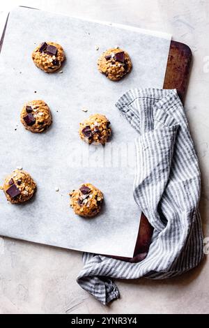 Oatmeal chocolate chip cookie dough scoops on a cookie sheet Stock Photo