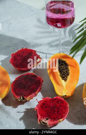 glass with cocktail, dragon fruit, also known as pitaya, cut open pink magenta-colored flesh with tiny black seeds, tropical fruits Stock Photo