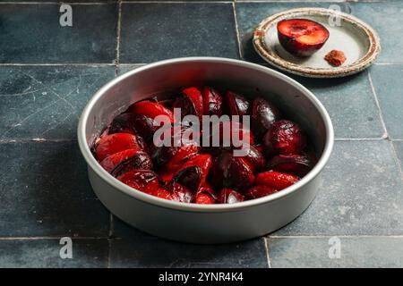 Plum tarte tatin before baking, red plums Stock Photo