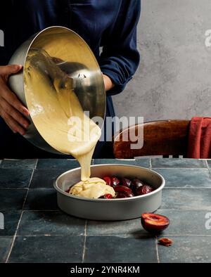 Plum tarte tatin before baking, red plums Stock Photo