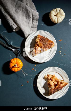 Pear Galette slices on a dark background with mini pumpkins Stock Photo