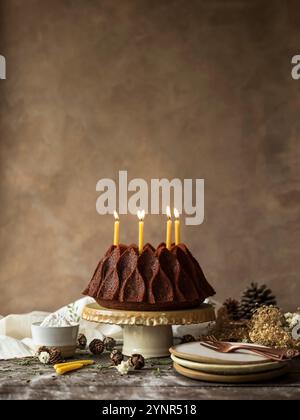 Christmas cake with candles on top. Rustic Mood and christmas decoration Stock Photo