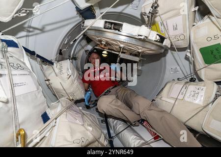 International Space Station, Earth Orbit. 05 November, 2024. NASA astronaut and Expedition 72 Flight Engineer Nick Hague waits in the vestibule between the forward port on the Harmony module and the SpaceX Dragon cargo spacecraft aboard the International Space Station, November 5, 2024 in Earth Orbit. Dragon docked to the orbital outpost less than hour before this photograph was taken and Hague is waiting for the hatch to open.  Credit: Astronaut Provided/NASA/Alamy Live News Stock Photo