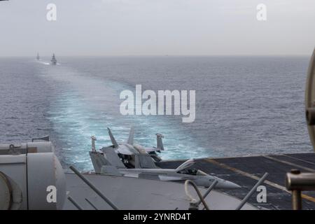 241125-N-SW048-1137 MEDITEERRANEAN SEA (Nov. 25, 2024) The Nimitz-class aircraft carrier USS Harry S. Truman (CVN 75) transits the Strait of Gibraltar alongside the Carlo Bergamini-class frigate Carbiniere (F 593) and the Spanish Álvaro de Bazán-class frigate Méndez Núñez (F-104), Nov. 25. USS Harry S. Truman, the flagship of the Harry S. Truman Carrier Strike Group (HSTCSG), is on a scheduled deployment in the U.S. 6th Fleet area of operations supporting U.S. Naval Forces Europe-Africa to defend U.S., Allied and partner interests. (U.S. Navy Photo by Mass Communication Specialist 3rd Class Lo Stock Photo