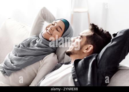 Relaxed muslim family resting after moving to their new house Stock Photo