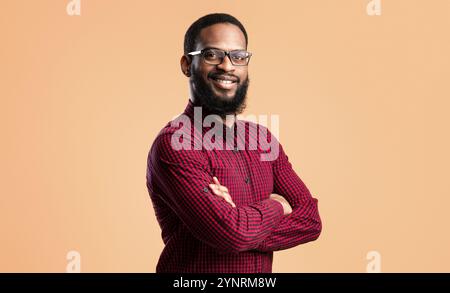 Smiling afro man posing on yellow background Stock Photo