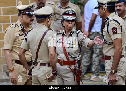 MUMBAI, INDIA - NOVEMBER 26: Reappointed Maharashtra DG Rashmi Shukla interacts with Mumbai CP Vivek Phansalkar, and Spl CP Deven Bharati after paying homage to the Martyrs of 26/11 attacks at Mumbai Police Headquarters on November 26, 2024 in Mumbai, India. On November 26, 2008, Mumbai terror attack, 10 armed militants from the Pakistan-based terrorist group Lashkar-e-Taiba (LeT) entered Mumbai via sea route and launched a series of attacks at prominent locations including the Taj Mahal Palace Hotel, Oberoi Trident Hotel, CST Railway Station, and Nariman House. As many as 166 people lost the Stock Photo