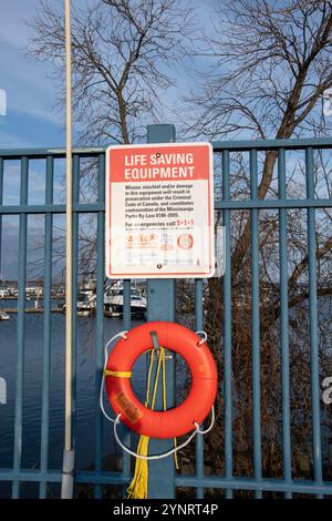 Life saving equipment sign and life ring at JJ Plaus Park in Port Credit, Mississauga, Toronto, Ontario, Canada Stock Photo