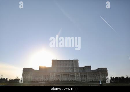 The Palace of Parliament (also known as the Republic's House or People's Palace), seen in Bucharest. It houses the Romanian Parliament, composed of the Chamber of Deputies and the Senate. Its construction was carried out by Communist dictator Nicolae Ceau?escu and completed in 1994. Designed by architect Anca Petrescu, its neo-classical style is inspired by the communist buildings of the 1950s. With an interior surface area of 350,000 m2, it is one of the largest buildings in Europe. Stock Photo