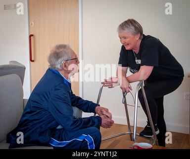 Care home resident talking to carer. Stock Photo