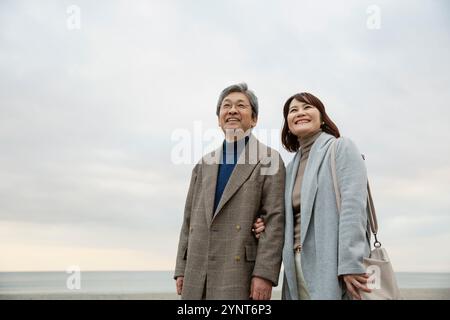 Smiling men and women standing under the evening sky Stock Photo