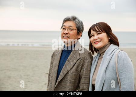 Smiling men and women standing under the evening sky Stock Photo