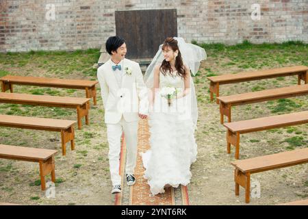 Bride and groom walking down aisle Stock Photo