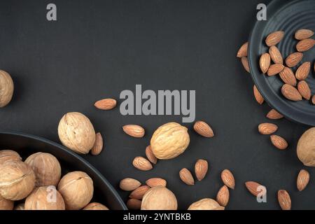 Dry fruits almonds and walnut in black background Stock Photo