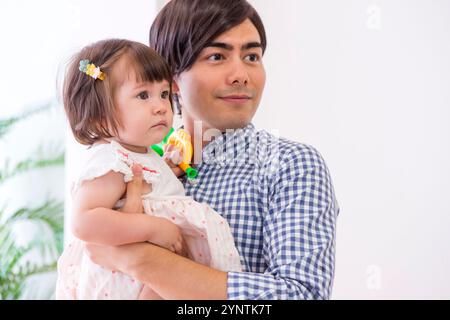 Girl being carried by family Stock Photo