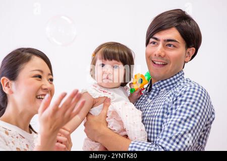 Girl being carried by family Stock Photo