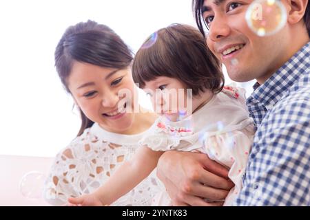 Girl being carried by family Stock Photo