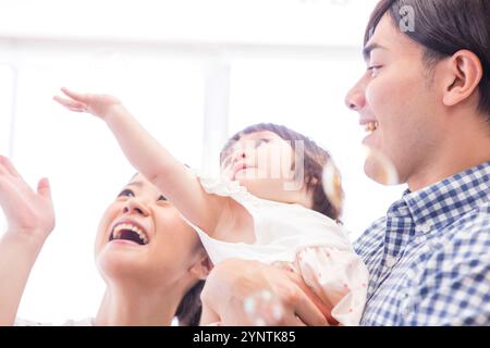 Girl being carried by family Stock Photo