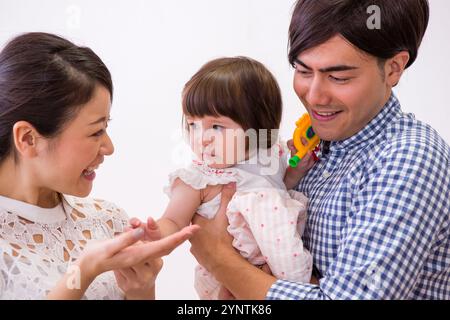 Girl being carried by family Stock Photo