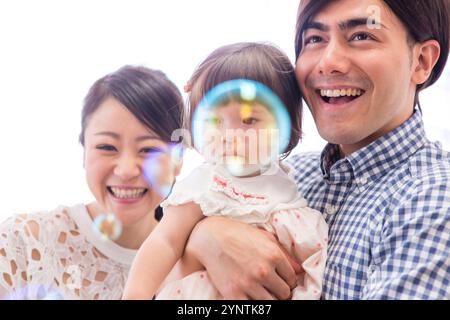 Girl being carried by family Stock Photo