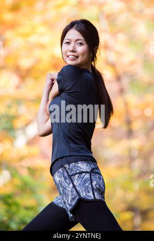 Upper view of stylish woman in black blouse sitting on couch in the