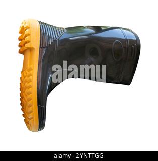 Side view of one side of black gumboot or black boot for working in garden is isolated on white background with clipping path. Stock Photo