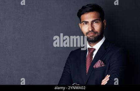 Studio, confidence and businessman in portrait for project, career and professional job for justice. Mockup space, indian lawyer or formal with arms Stock Photo