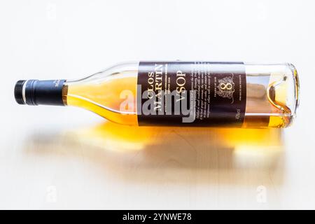 Moscow, Russia - October 1, 2024: glass bottle of Clos Martin Bas Armagnac lies on light brown wooden board Stock Photo