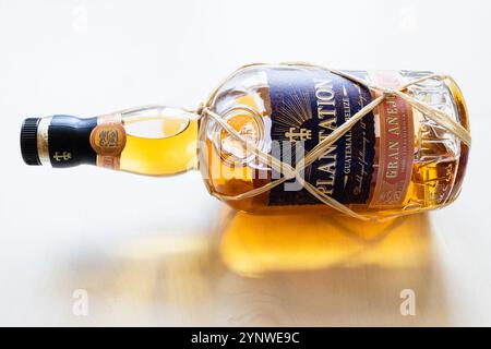 Moscow, Russia - October 1, 2024: lying glass bottle of Plantation Gran Anejo Rum on light brown wooden board Stock Photo