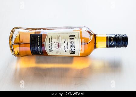 Moscow, Russia - October 1, 2024: lying glass bottle of Bacardi OakHeart Rum on light brown wooden board Stock Photo